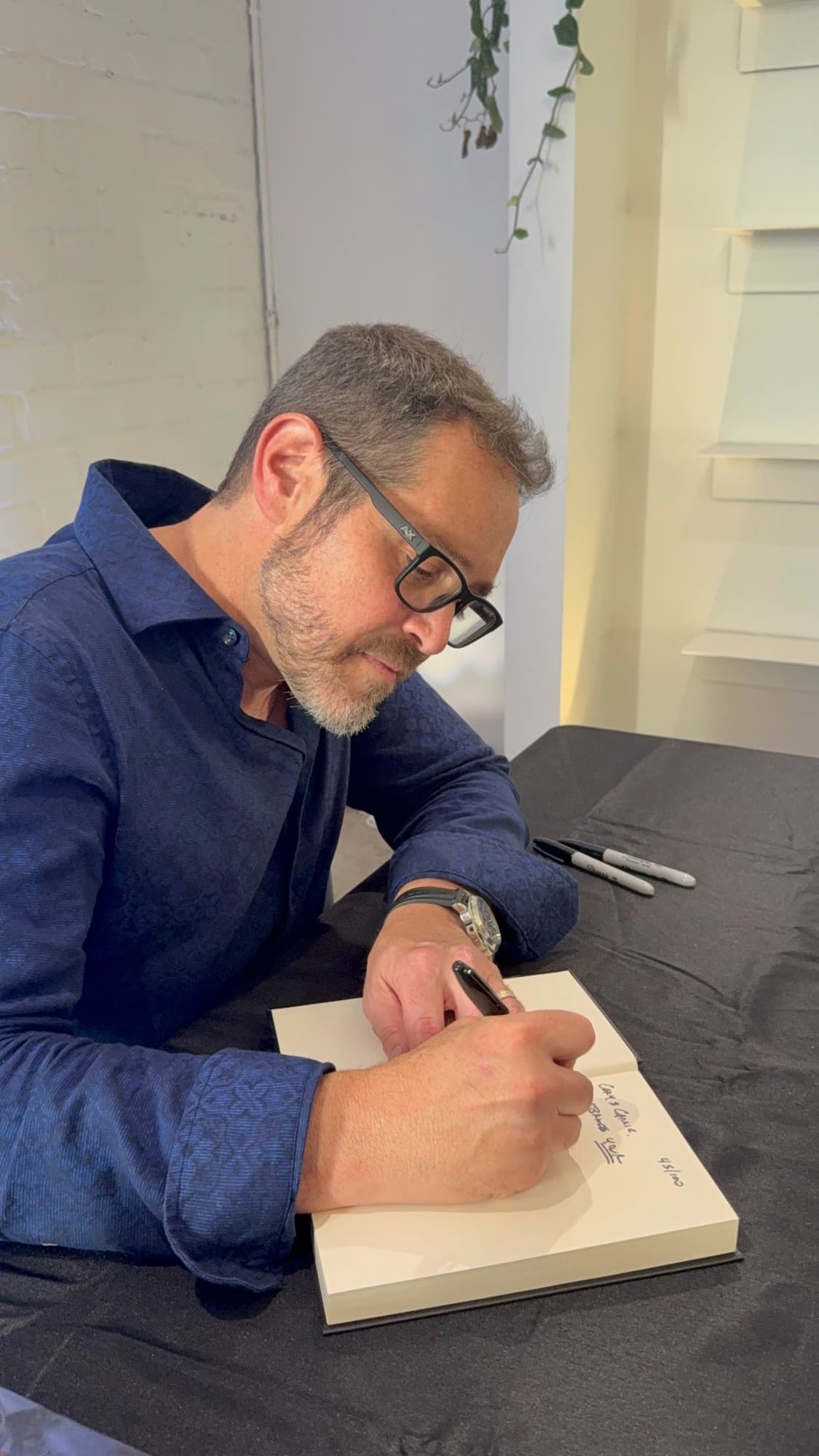 Brett signing books